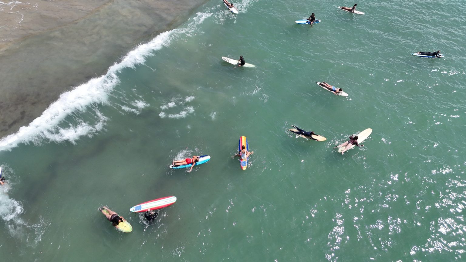 Aerial view of women surfing together at a Ventura Surf Girlies meetup in Ventura, CA